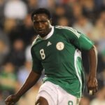 Soccer player in a green Nigeria style jersey with number 8 sprinting on the field amid a blurred crowd  trybalnews