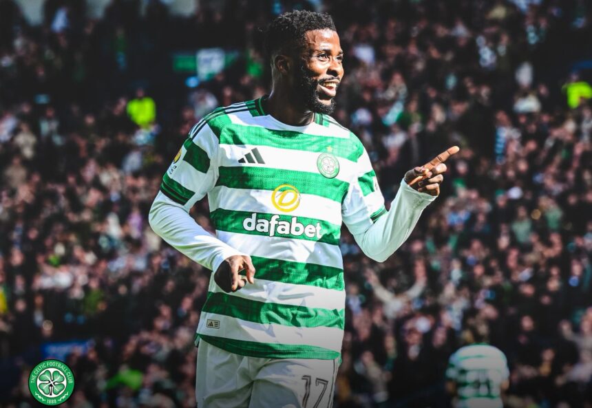 Celtic FC player in green and white hoops celebrating pointing with his right hand while the crowded stadium cheers behind him  trybalnews