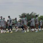 A group of young soccer players in gray uniforms walking in a line on a turf field during practice  trybalnews