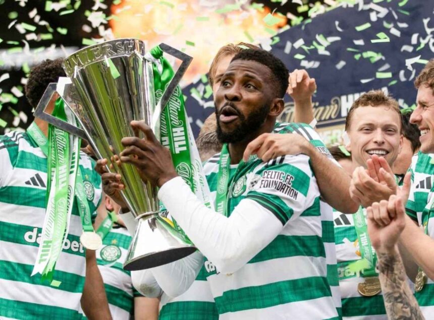 Celtic FC players celebrate victory lifting a tall silver trophy with green ribbons and confetti flying around  trybalnews