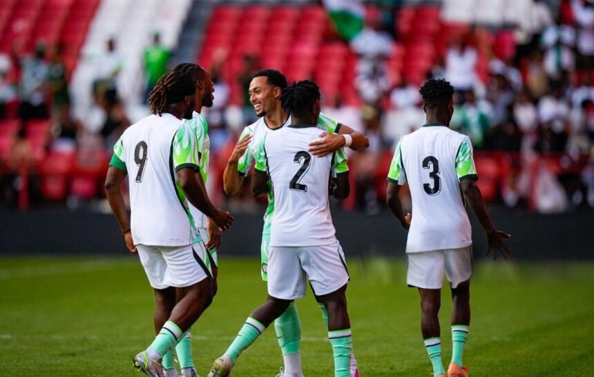 Group of soccer players in white and green uniforms celebrate on a green pitch with numbers 9 2 and 3 on their backs  trybalnews