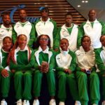Group of athletes in matching green and white tracksuits posing for a team photo indoors  trybalnews