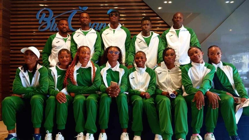 Group of athletes in matching green and white tracksuits posing for a team photo indoors  trybalnews