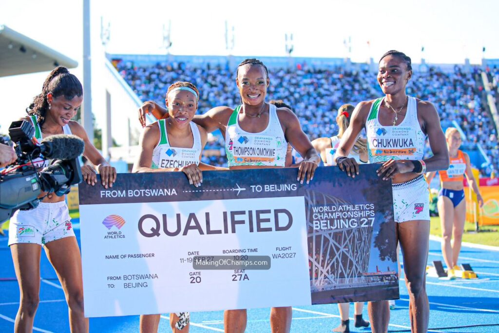WhatsApp Image 20260503 at 183457 Trybal News Four female athletes stand on a blue track smiling and hold a large banner reading QUALIFIED with a World Athletics logo as a camera records them From Botswana to Beijing they celebrate qualification after a race at the stadium trybalnews