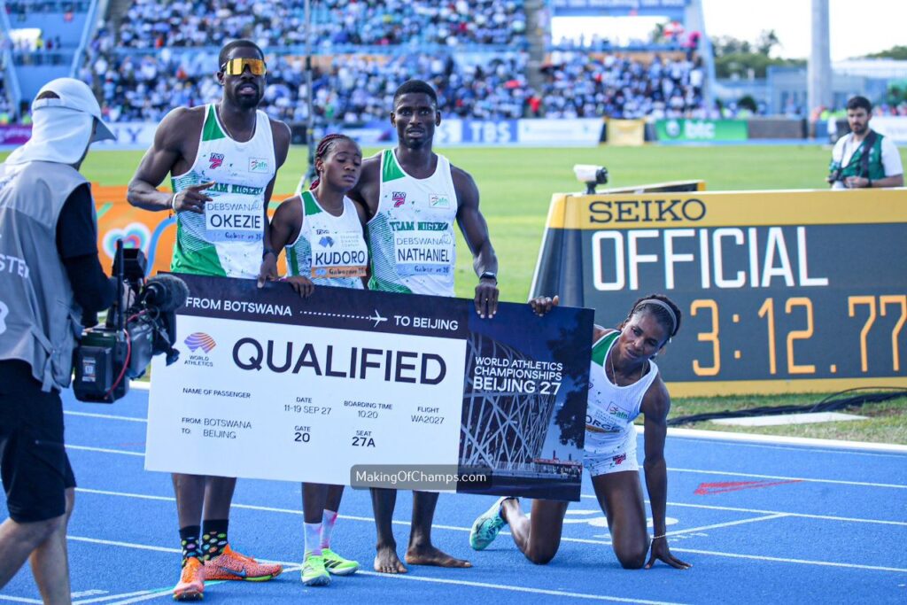 WhatsApp Image 20260503 at 183704 Trybal News Four Botswana track athletes pose on a blue track holding a large QUALIFIED boarding pass banner for Beijing as a camera crew films them trybalnews