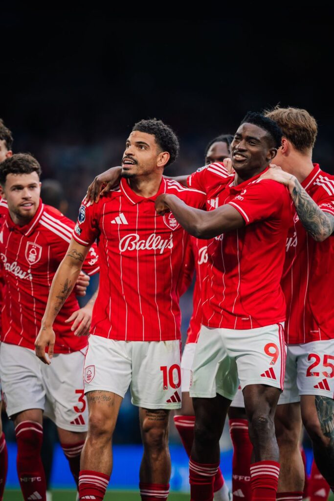 WhatsApp Image 20260504 at 192725 Trybal News Group of soccer players in red striped kits celebrate with arms around each other on the field trybalnews