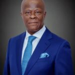 Professional head and shoulders portrait of a man in a cobalt blue suit white shirt blue tie and matching pocket square  trybalnews