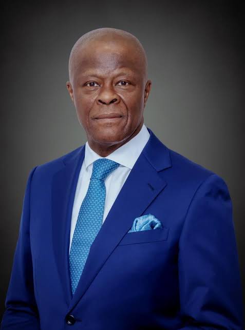 Professional head and shoulders portrait of a man in a cobalt blue suit white shirt blue tie and matching pocket square  trybalnews