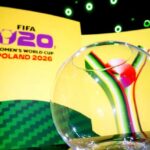 Branding for FIFA Womens World Cup Poland 2026 with a glass globe in the foreground on a yellow stage backdrop  trybalnews