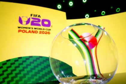 Branding for FIFA Women's World Cup Poland 2026 with a glass globe in the foreground on a yellow stage backdrop.