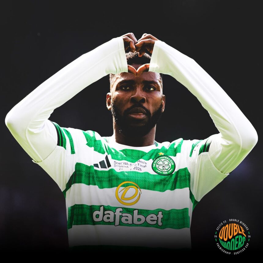 Soccer player in a green and white hooped jersey forms a heart shape with his arms during a celebration on the field  trybalnews