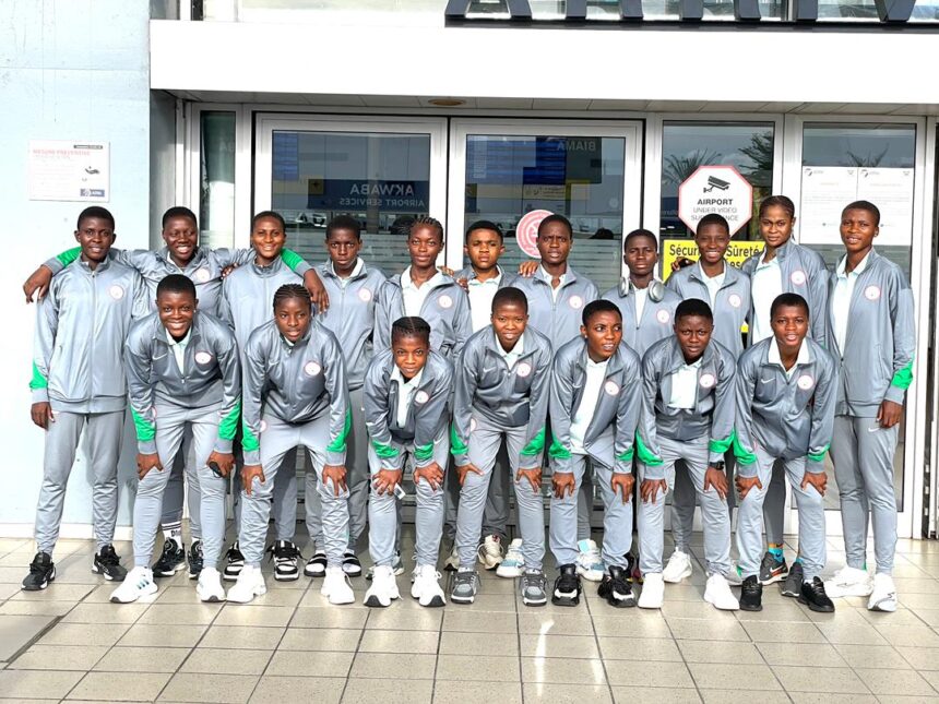 Group of 18 young athletes in matching gray tracksuits with green accents pose for a team photo outside a building  trybalnews