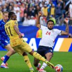 Ghana forward Antoine Semenyo wearing yellow 11 jersey attempts a shot on goal as England defender Reece James in white 24 jersey blocks the attempt Action near goalpost during FIFA World Cup 2026 Group L match between England and Ghana at Boston Stadium Foxborough Massachusetts on June 23 2026 Goalkeeper visible in background  trybalnews