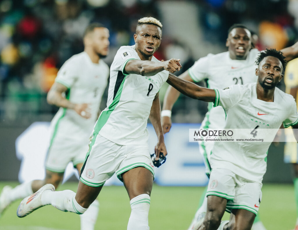 Rwanda vs Nigeria World Cup qualifier Kigali Rwanda Trybal News Soccer players in white and green uniforms celebrate on the field one pointing toward the camera as teammates rush in trybalnews