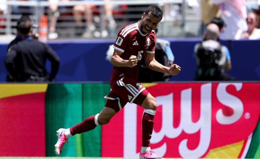 Male soccer player in a maroon jersey 16 celebrating with clenched fists on the pitch  trybalnews