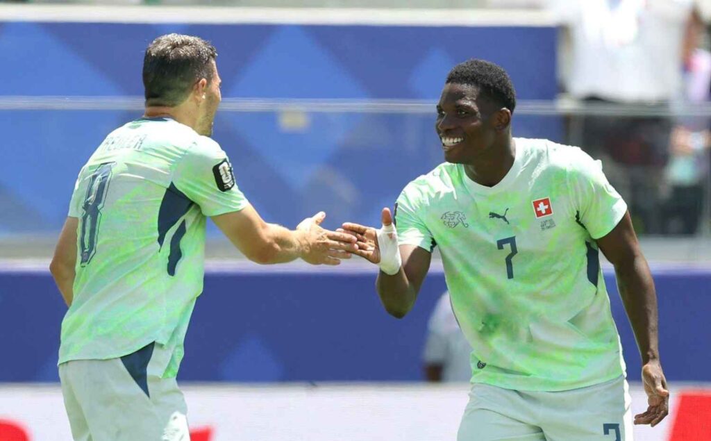 BreelEmbolo Trybal News Breel Embolo of Switzerland celebrates with Remo Freuler after scoring a penalty for the teamaposs first goal during the FIFA World Cup 2026 Group B match between Qatar and Switzerland trybalnews
