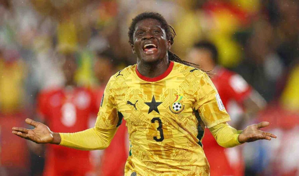 Caleb Yirenkyi Trybal News Ghana national team player in a yellow kit celebrating with arms outstretched on the field trybalnews