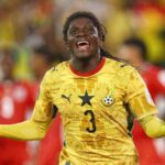 Ghana national team player in a yellow kit celebrating with arms outstretched on the field  trybalnews
