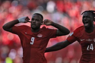 Canada's forward Cyle Larin (L) celebrates after scoring a goal during the 2026 World Cup Group B football match between Canada and Bosnia and Herzegovina at the Toronto Stadium.