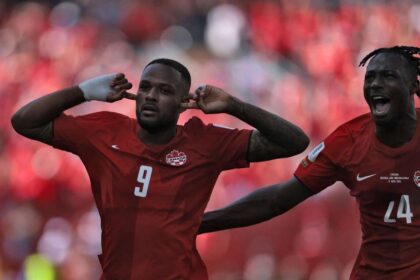 Canada's forward Cyle Larin (L) celebrates after scoring a goal during the 2026 World Cup Group B football match between Canada and Bosnia and Herzegovina at the Toronto Stadium.