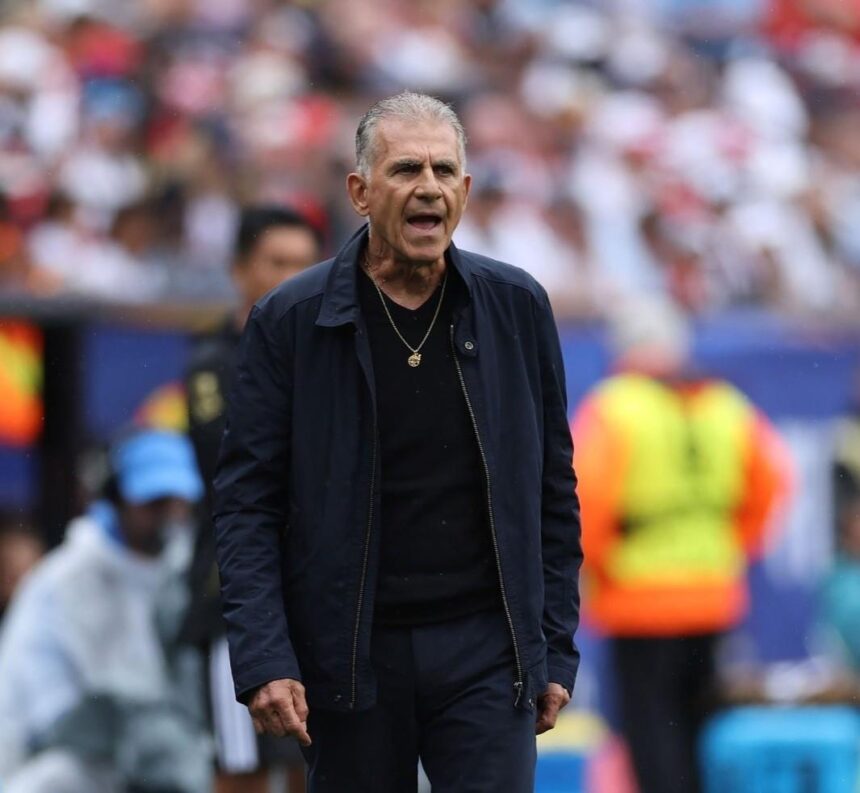 Ghana head coach Carlos Queiroz stands on the sideline wearing a navy jacket and black shirt with a gold necklace He appears to be shouting instructions with an intense expression during the FIFA World Cup 2026 Group L match between England and Ghana at Boston Stadium Foxborough Massachusetts on June 23 2026 Blurred crowd and stadium staff visible in background  trybalnews