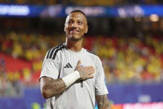 Eloy Room, Curaçao goalkeeper wearing number 1 gray jersey, places hand over heart and applauds fans after a 0-0 draw at Kansas City Stadium during FIFA World Cup 2026 Group E match vs Ecuador on June 20, 2026.