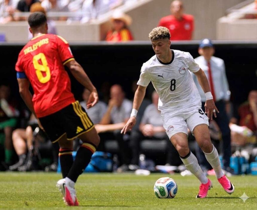 Soccer player in white number 8 dribbling the ball toward the goal while guarded by a opponent in red jersey on a sunny field  trybalnews