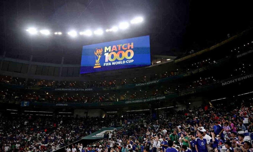 A wide general view of Monterrey Stadium at night during FIFA World Cup 2026 The large stadium screen displays MATCH 1000 FIFA WORLD CUP in colorful letters with the World Cup trophy logo on a blue background Bright stadium floodlights illuminate the stands which are filled with fans wearing Tunisia and Japan colors Banners reading COPA MUNDIAL DE LA FIFA 2026 and MONTERREY are visible on the stadium tiers The photo was taken on June 20 2026 before the Group F match between Tunisia and Japan in Monterrey Mexico  trybalnews