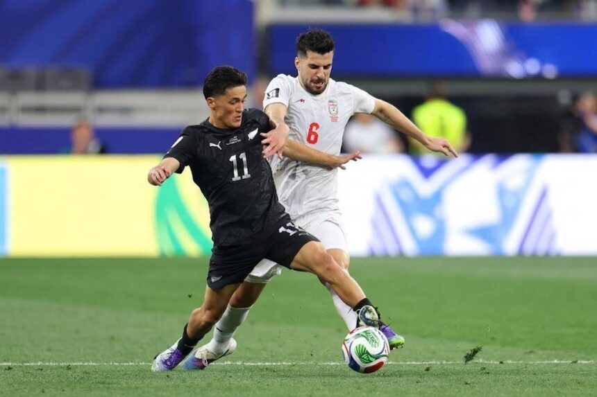 Two soccer players compete for the ball during a match one in black kit number 11 shielding the ball from a white kit opponent number 6  trybalnews