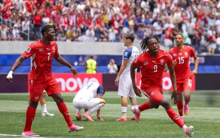 Switzerland forward Johan Manzambi celebrates after scoring his teams first goal during the FIFA World Cup 2026 Group B match between Switzerland and Bosnia and Herzegovina at Los Angeles Stadium in Inglewood California on June 18 2026 Manzambi wears a red Switzerland kit with white socks and pink boots arms outstretched as he runs  trybalnews