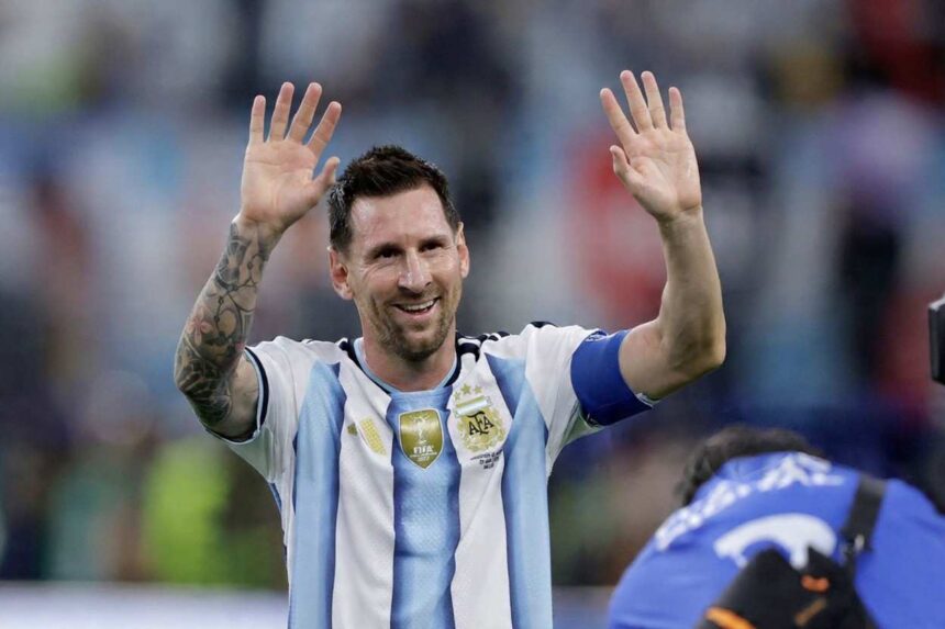 Argentina footballer in a blue and white striped kit raises both hands in celebration to the crowd  trybalnews
