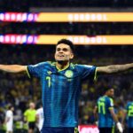 Colombian soccer goalkeeper in a blue kit with arms extended in celebration on the field  trybalnews