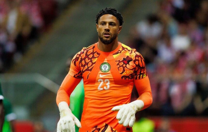 Nigerian goalkeeper in bright orange jersey with number 23 gloves on standing on the field during a match  trybalnews