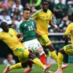 Soccer match action a Mexican player controls the ball as South African defenders close in  trybalnews