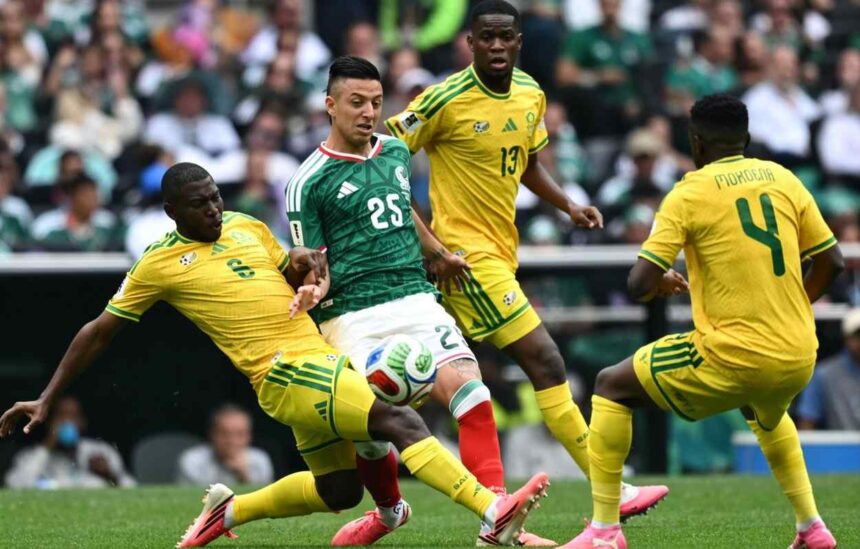 Soccer match action a Mexican player controls the ball as South African defenders close in  trybalnews