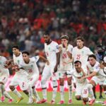 Morocco football players in white Puma kits with red numbers dash forward in celebration on the pitch The group includes players wearing 3 2 26 14 24 15 16 and 9 all with arms outstretched mouths open and intense expressions of joy This is after Ismael Saibari 11 scored Moroccos fifth and winning penalty in the shootout The FIFA World Cup 2026 Round of 32 match between Netherlands and Morocco was played on June 29 2026 at Monterrey Stadium in Guadalupe Mexico A packed stadium crowd and a red Coca Cola advertising hoarding are visible in the background  trybalnews