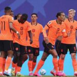 Netherlands striker Brian Brobbey wearing orange 19 Nike jersey with black shorts and orange socks celebrates with teammates after scoring Brobbey is center left head down with teammates around him Cody Gakpo 11 stands to his left with his back to camera Virgil van Dijk 4 is to the right wearing a white captains armband and long sleeve orange jersey and Matthijs de Ligt 6 is far right FIFA World Cup 2026 Group F match between Tunisia and Netherlands at Kansas City Stadium Kansas City Missouri on June 25 2026 Blue stadium backdrop with a football on the grass behind them  trybalnews