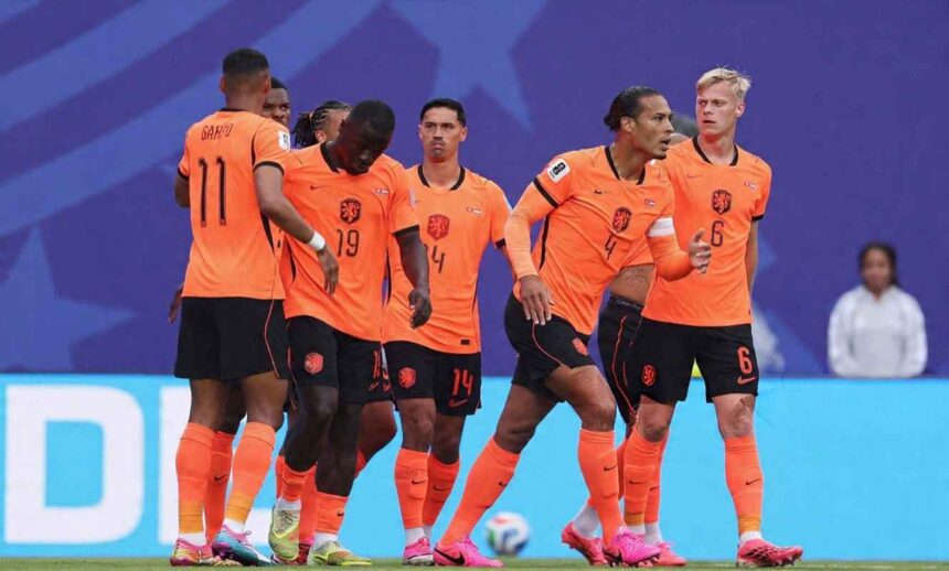 Netherlands striker Brian Brobbey wearing orange 19 Nike jersey with black shorts and orange socks celebrates with teammates after scoring Brobbey is center left head down with teammates around him Cody Gakpo 11 stands to his left with his back to camera Virgil van Dijk 4 is to the right wearing a white captains armband and long sleeve orange jersey and Matthijs de Ligt 6 is far right FIFA World Cup 2026 Group F match between Tunisia and Netherlands at Kansas City Stadium Kansas City Missouri on June 25 2026 Blue stadium backdrop with a football on the grass behind them  trybalnews