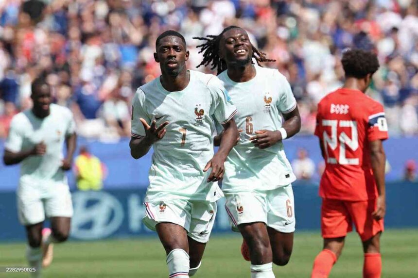 France forward Ousmane Dembele 7 in a light mint green away kit with gold number 7 and the FFF rooster crest runs forward with both hands gesturing after scoring Midfielder Manu Kone 6 with dreadlocks wearing the same kit with gold number 6 smiles and runs beside him A Norway player 22 in a red kit walks away in the background 2026 FIFA World Cup Group I match between Norway and France at Boston Stadium Foxborough on June 26 2026 Packed crowd and blue advertising boards behind the pitch  trybalnews