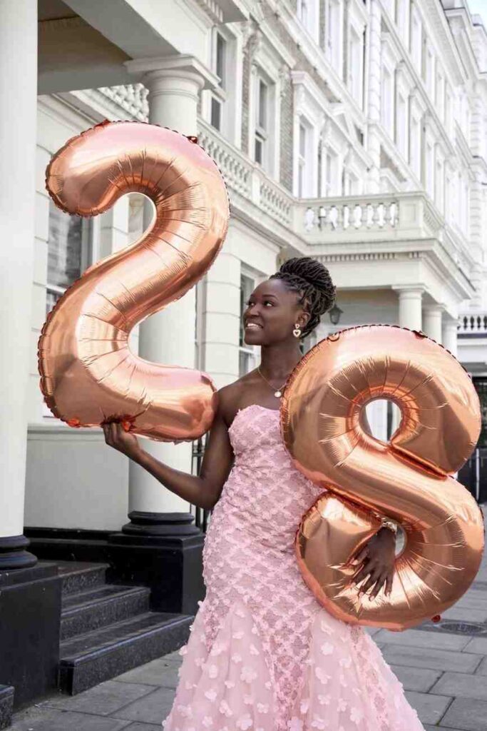 RinsolaBabajide Trybal News Nigeria footballer Rinsola Babajide in a blush pink strapless mermaid gown with sweetheart neckline sheer overlay and 3D floral appliqués in a diamond pattern on the bodice with scattered florals on the flared maxi skirt She wears strappy metallic heels minimal gold jewelry and a braided updo trybalnews