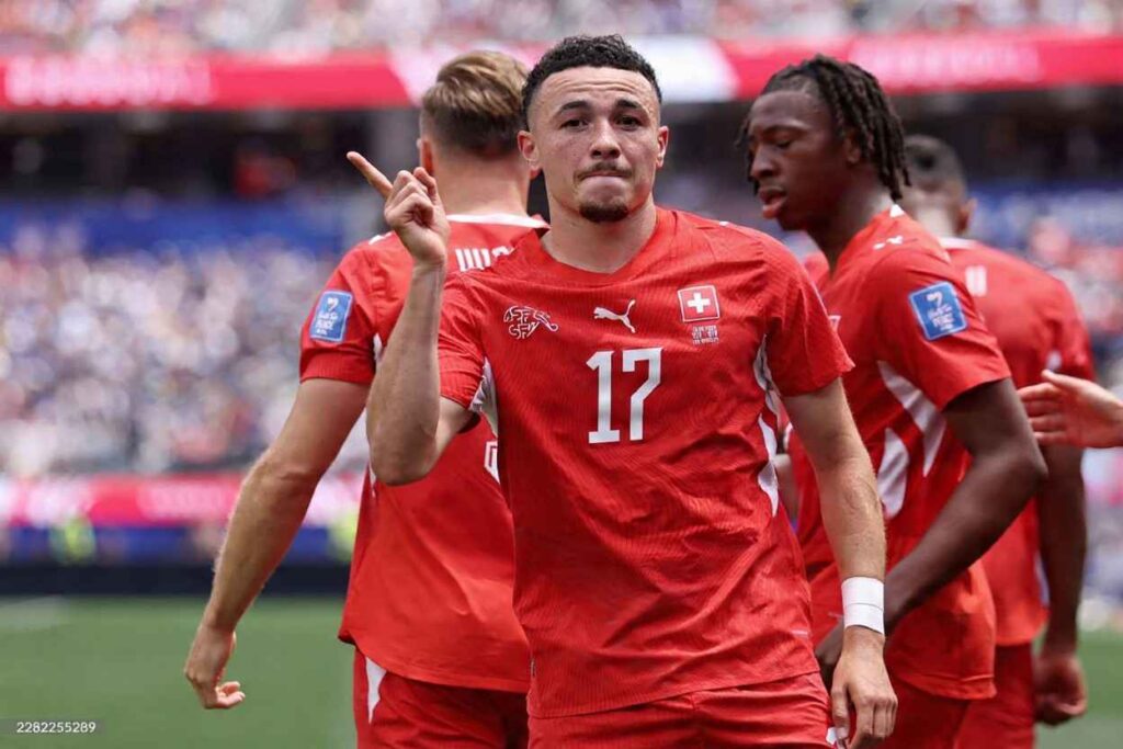 Ruben Vargas Trybal News Switzerland midfielder Ruben Vargas celebrates after scoring his teamaposs second goal during the FIFA World Cup 2026 Group B match between Switzerland and Bosnia and Herzegovina at Los Angeles Stadium in Inglewood California on June 18 2026 Vargas wears a red Switzerland kit with number 17 visible mouth open and fist clenched as he celebrates Teammates in red kits are visible around him trybalnews