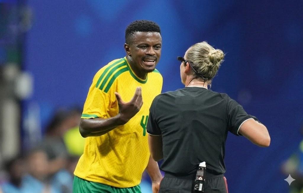 South Africa midfielder Teboho Mokoena and USA referee Tori Penso gesture to each other during the FIFA World Cup 2026 Group A match between Czechia and South Africa at Atlanta Stadium Atlanta USA on June 18 2026 Mokoena wears a green and yellow South Africa kit Penso wears a black referee uniform  trybalnews