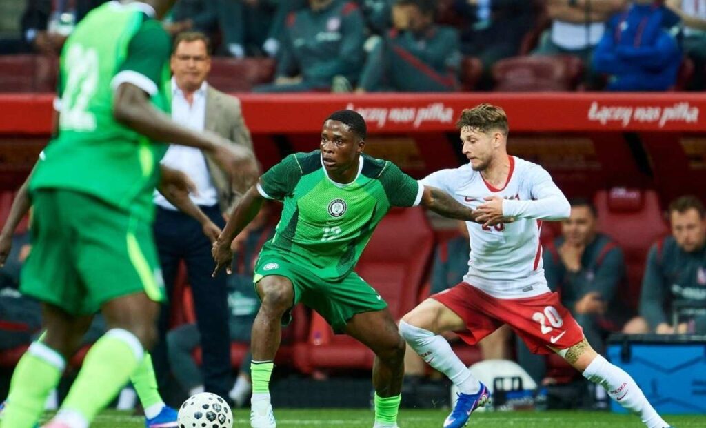 Tochukwu Nnadi of Nigeria L fights for the ball with R Sebastian Szymanski from Poland during the international friendly match between Poland and Super Eagles at the PGE National Stadium on June 3 2026 in Warsaw Poland Photo by Adam NurkiewiczGetty Images  trybalnews