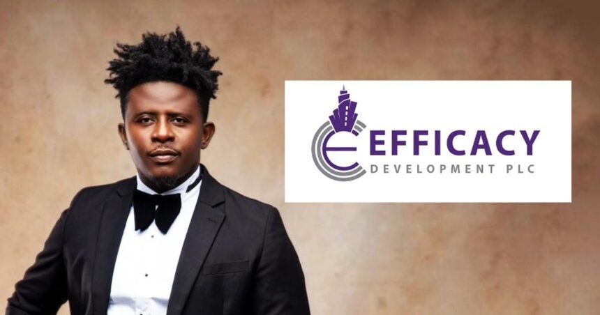 Portrait of a man in a black tuxedo and bow tie beside the EFFICIACY DEVELOPMENT PLC logo on a white panel  trybalnews