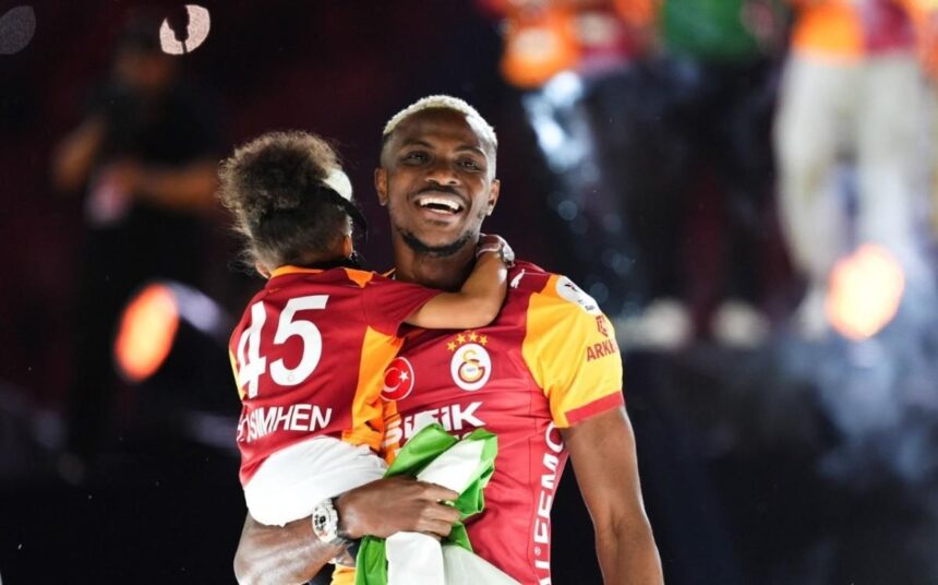 Two Galatasaray players celebrate hugging on the field with smiles and a flagcloth in hand  trybalnews