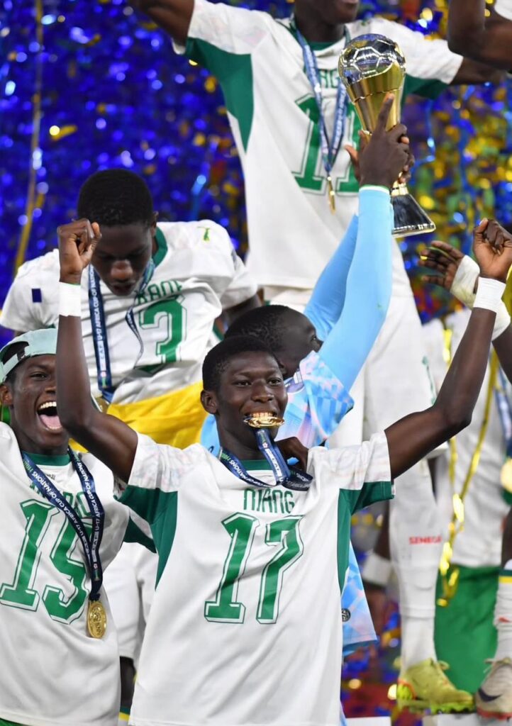 WhatsApp Image 20260603 at 090734 Trybal News Soccer players in white and green celebrate a victory lifting a trophy amid blue confetti trybalnews