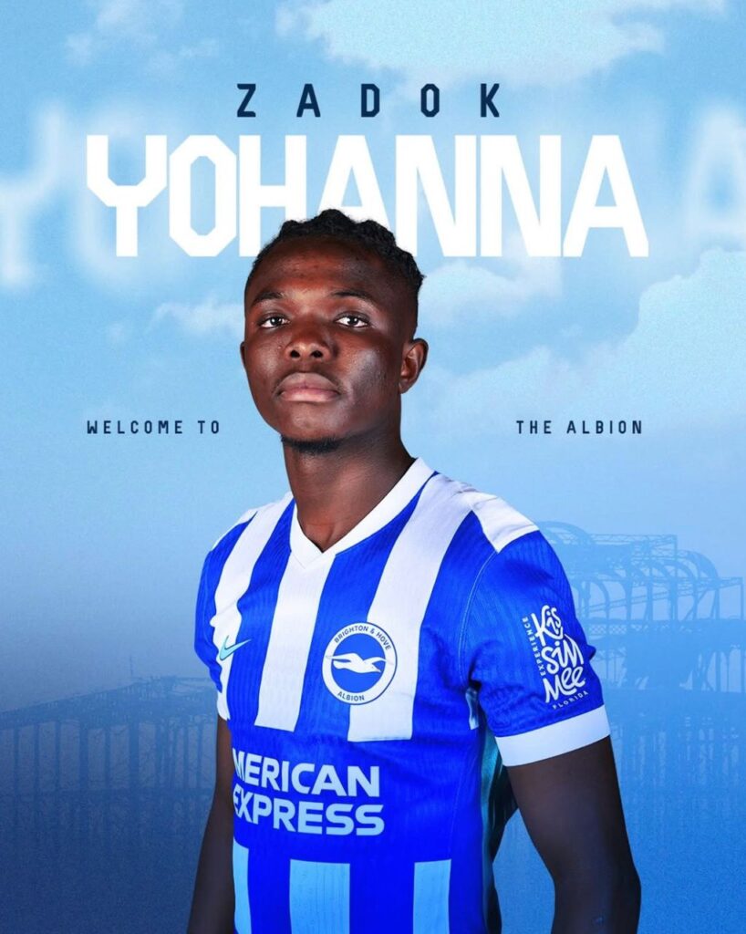 WhatsApp Image 20260606 at 185537 Trybal News Promotional poster featuring a young footballer in a blue and white striped kit against a blue sky with the name text ZADOK YOHANNA above him trybalnews