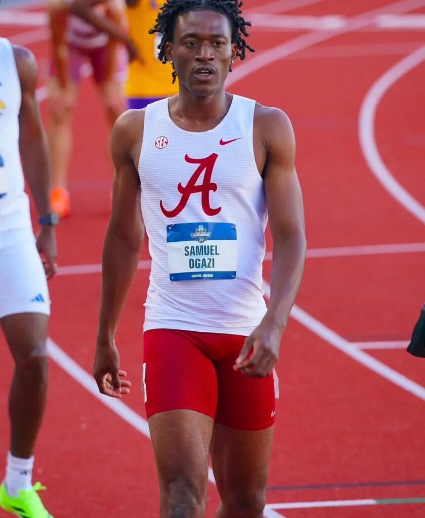 Male sprinter in a white Alabama singlet with red A red shorts and race bib Samuel Ogazi on a red track surface  trybalnews