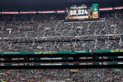 Crowd fills a large football stadium in Mexico City for a FIFA World Cup 2026 match, with a scoreboard displaying attendance 80,824 and 'Fuel House' text.