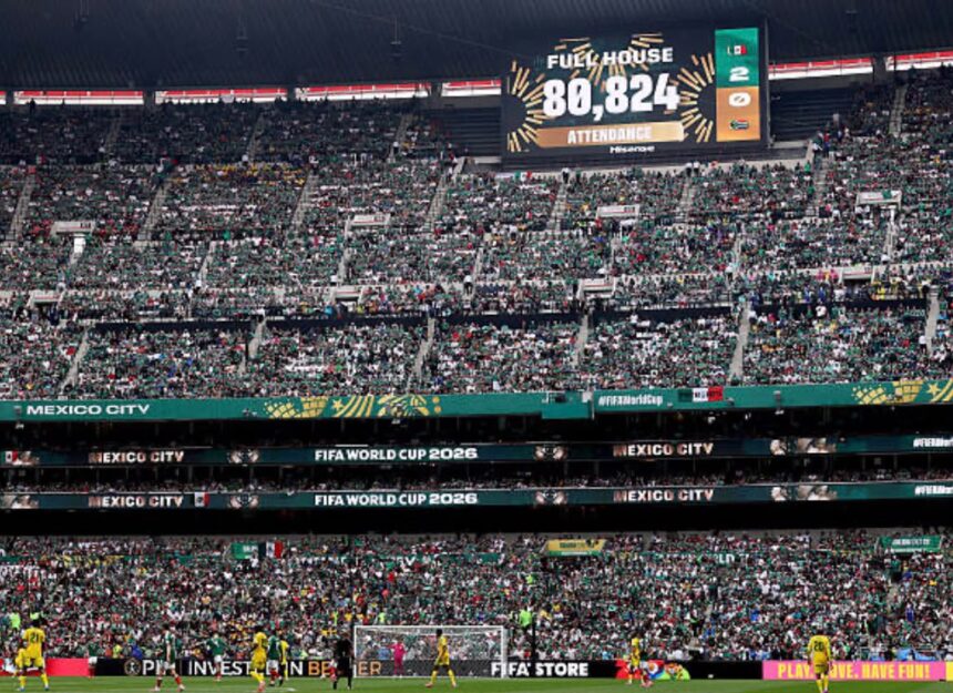 Crowd fills a large football stadium in Mexico City for a FIFA World Cup 2026 match with a scoreboard displaying attendance 80824 and Fuel House text  trybalnews